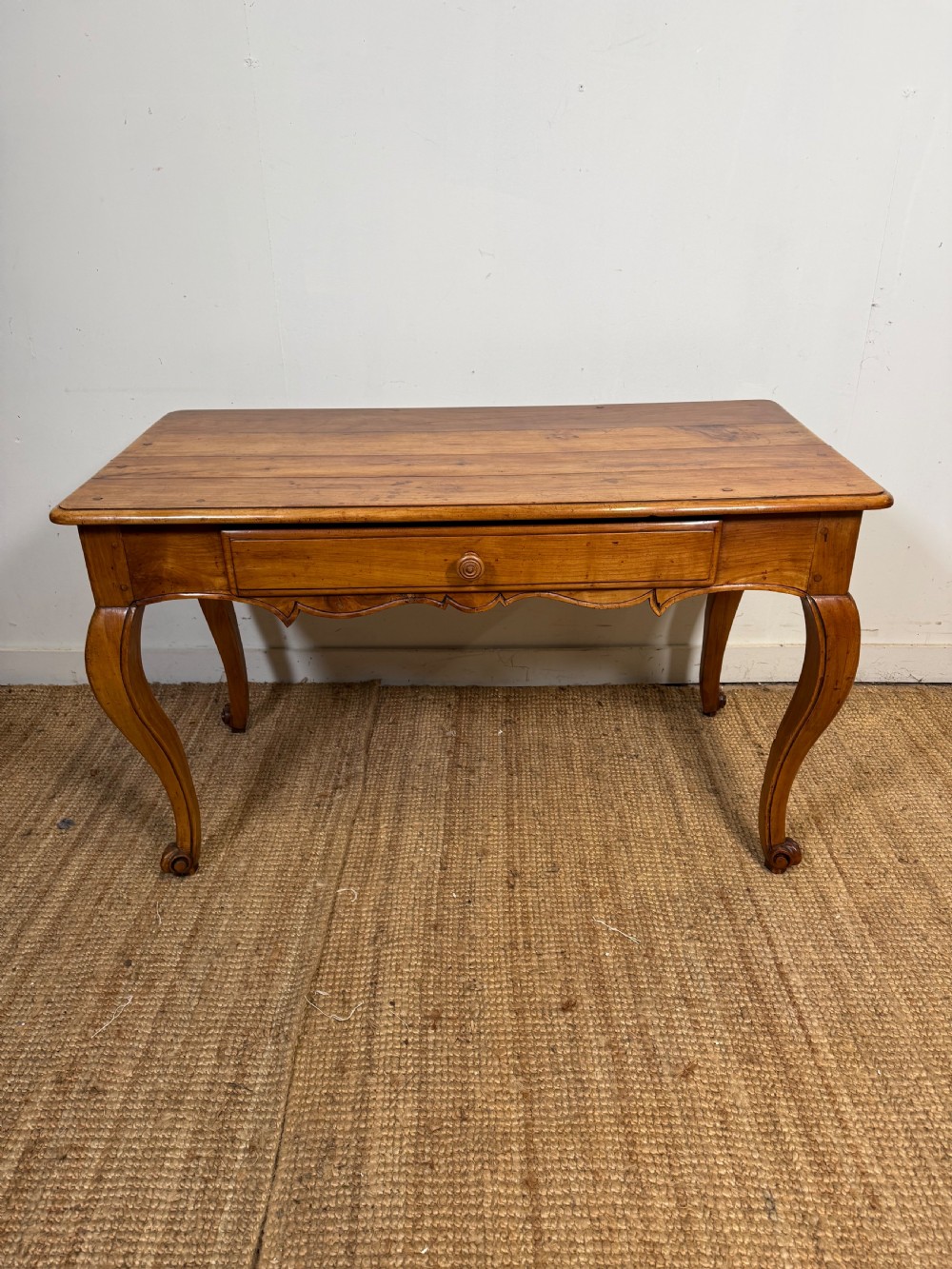 An early nineteenth-century French cherrywood side table featuring cabriole legs, a contoured apron with a single drawer, and a warm honey-coloured timber finish. View II