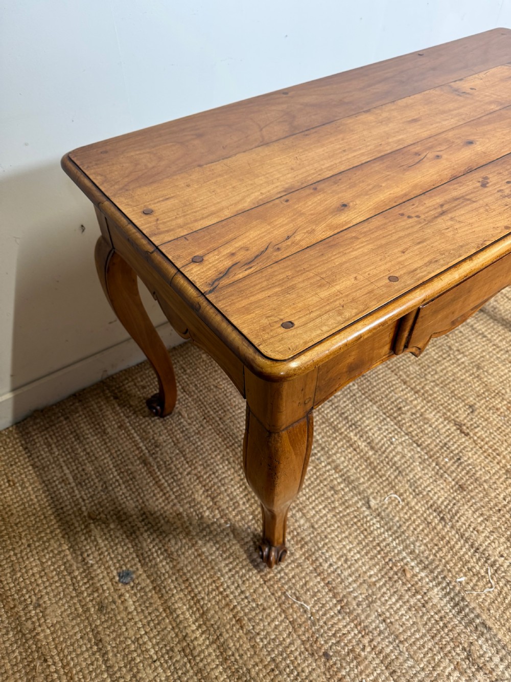 An early nineteenth-century French cherrywood side table featuring cabriole legs, a contoured apron with a single drawer, and a warm honey-coloured timber finish. View III