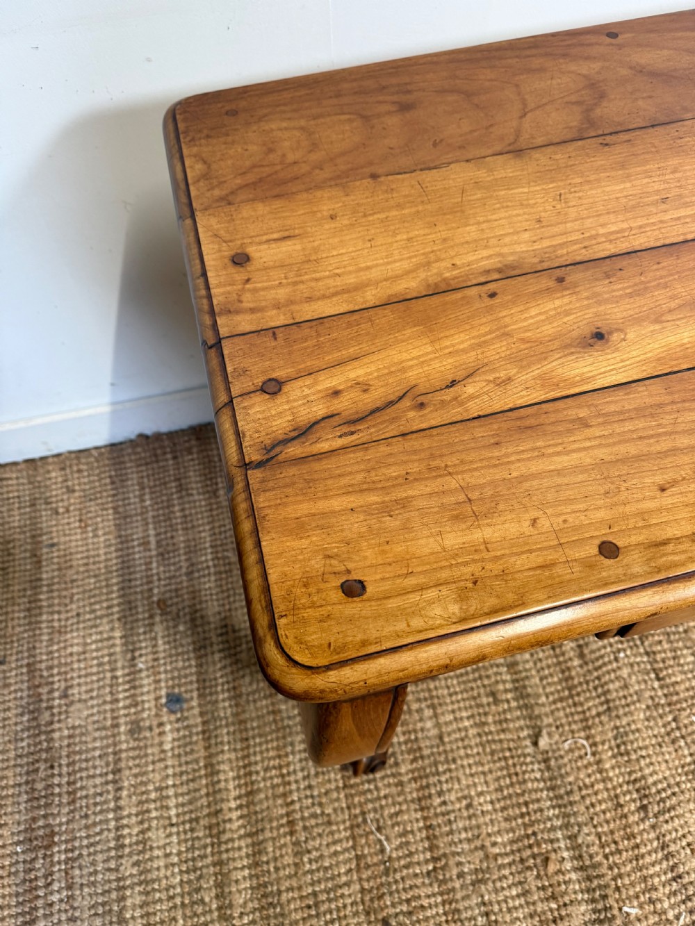 An early nineteenth-century French cherrywood side table featuring cabriole legs, a contoured apron with a single drawer, and a warm honey-coloured timber finish. View V