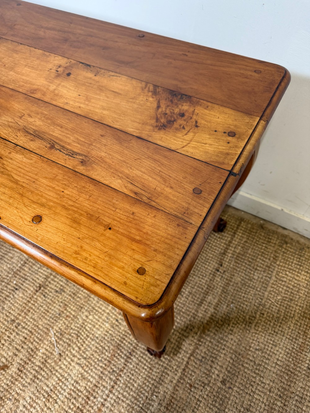 An early nineteenth-century French cherrywood side table featuring cabriole legs, a contoured apron with a single drawer, and a warm honey-coloured timber finish. View VI