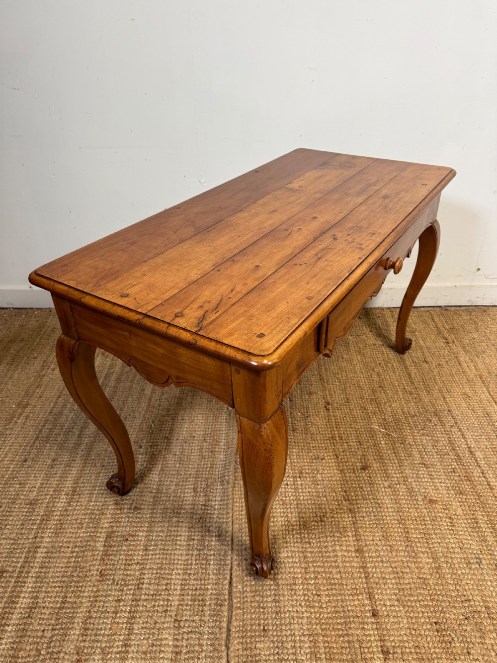 An early nineteenth-century French cherrywood side table featuring cabriole legs, a contoured apron with a single drawer, and a warm honey-coloured timber finish. View XI