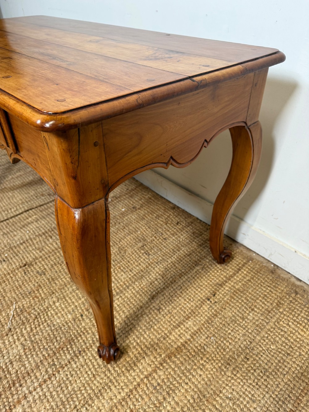 An early nineteenth-century French cherrywood side table featuring cabriole legs, a contoured apron with a single drawer, and a warm honey-coloured timber finish. View XIII