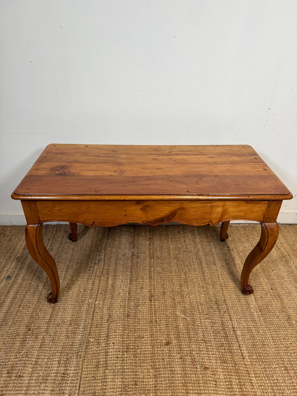 An early nineteenth-century French cherrywood side table featuring cabriole legs, a contoured apron with a single drawer, and a warm honey-coloured timber finish. View XIV