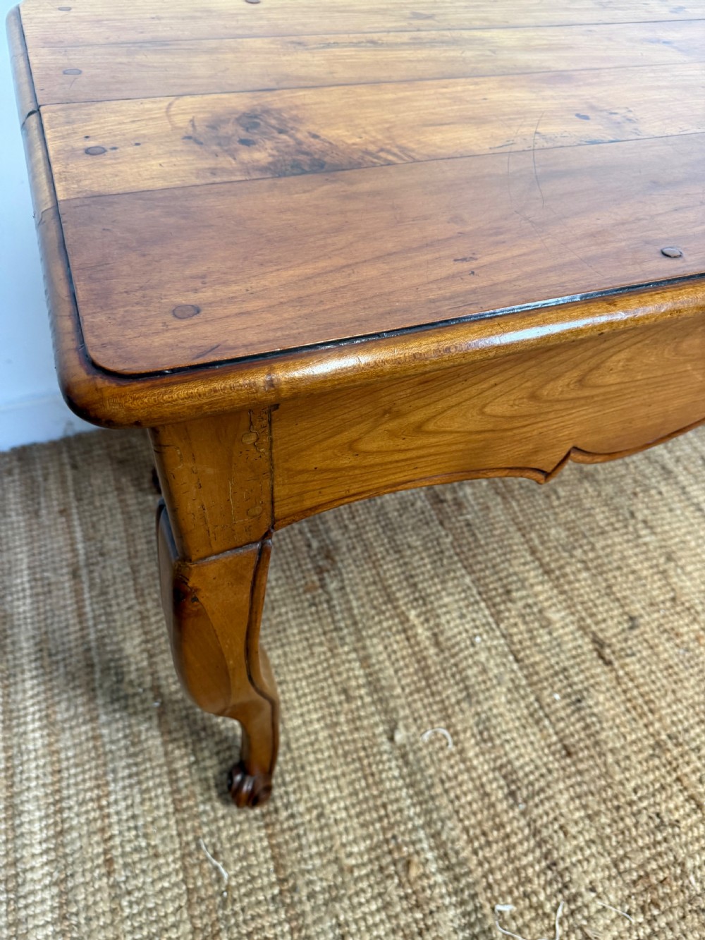 An early nineteenth-century French cherrywood side table featuring cabriole legs, a contoured apron with a single drawer, and a warm honey-coloured timber finish. View XV