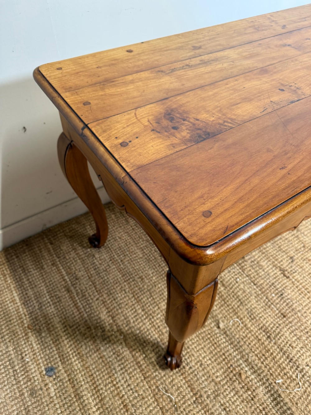 An early nineteenth-century French cherrywood side table featuring cabriole legs, a contoured apron with a single drawer, and a warm honey-coloured timber finish. View XVI