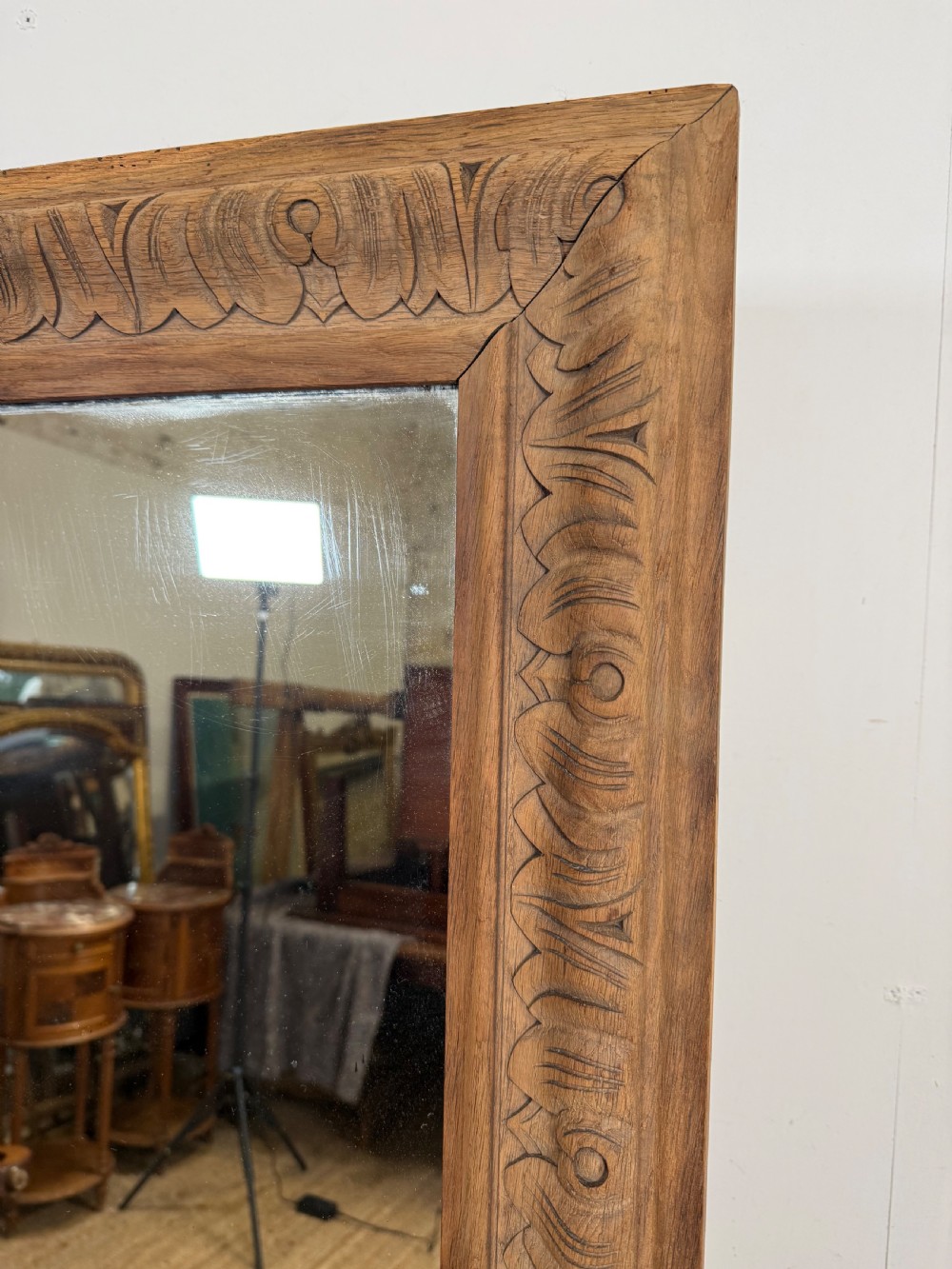 A large rectangular 19th-century wall mirror featuring a wide, hand-carved scrubbed oak frame with foliate border detailing. View II