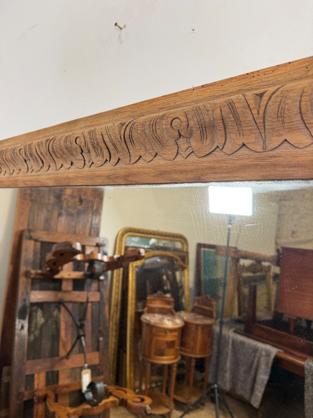 A large rectangular 19th-century wall mirror featuring a wide, hand-carved scrubbed oak frame with foliate border detailing. View III