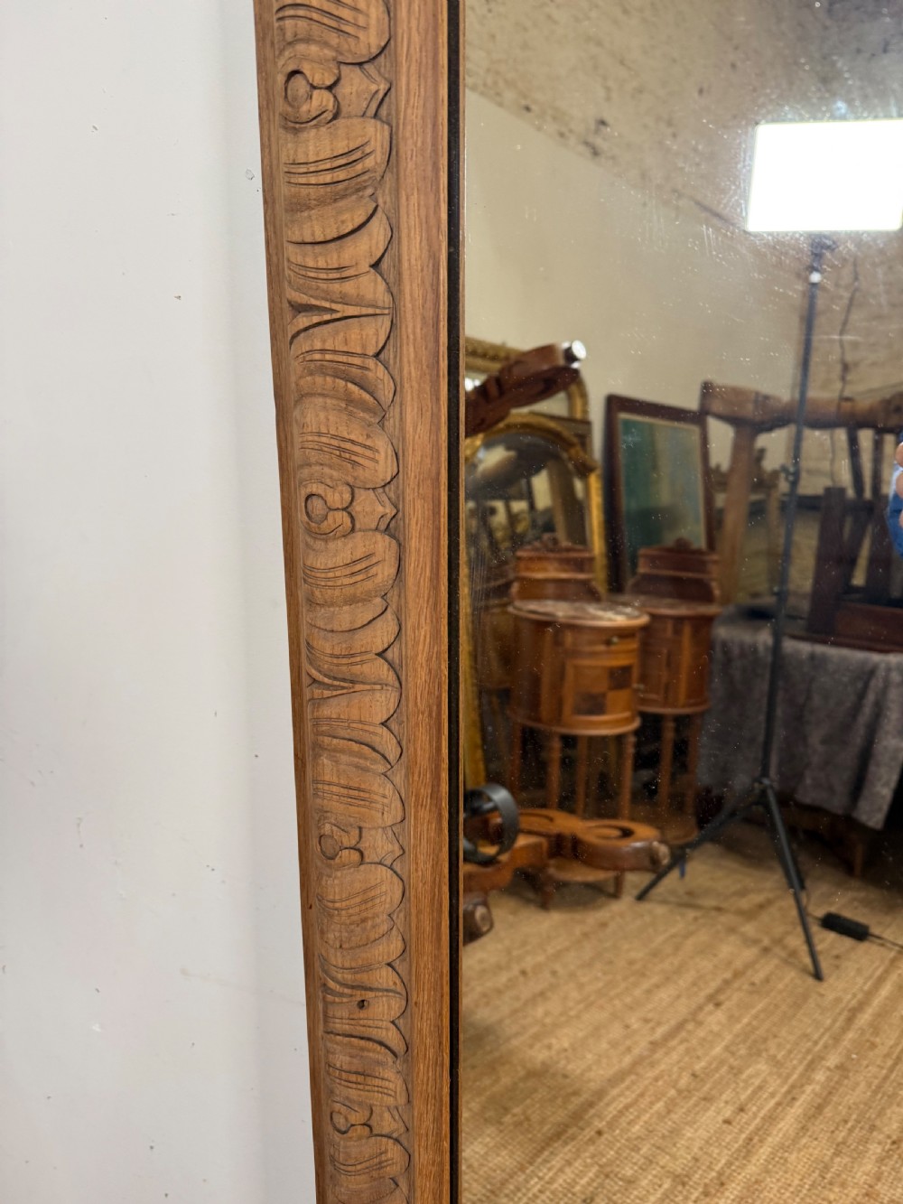 A large rectangular 19th-century wall mirror featuring a wide, hand-carved scrubbed oak frame with foliate border detailing. View VI