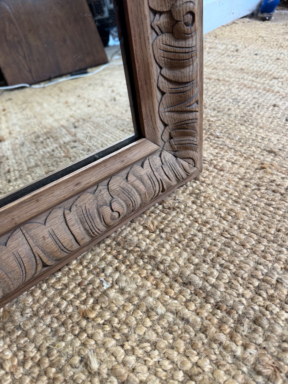A large rectangular 19th-century wall mirror featuring a wide, hand-carved scrubbed oak frame with foliate border detailing. View X