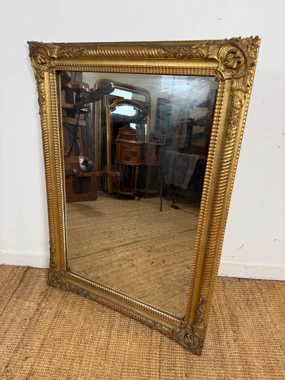 A large rectangular 19th-century French wall mirror featuring a gold leaf gesso frame with rope twist borders and decorative corner flourishes. View II