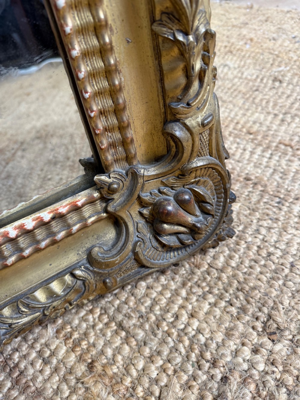 A large rectangular 19th-century French wall mirror featuring a gold leaf gesso frame with rope twist borders and decorative corner flourishes. View VIII