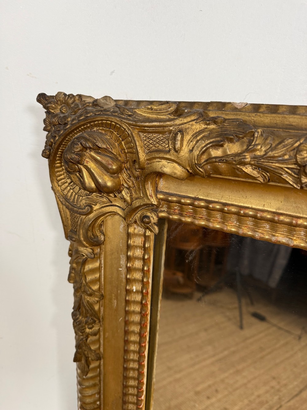 A large rectangular 19th-century French wall mirror featuring a gold leaf gesso frame with rope twist borders and decorative corner flourishes. View X
