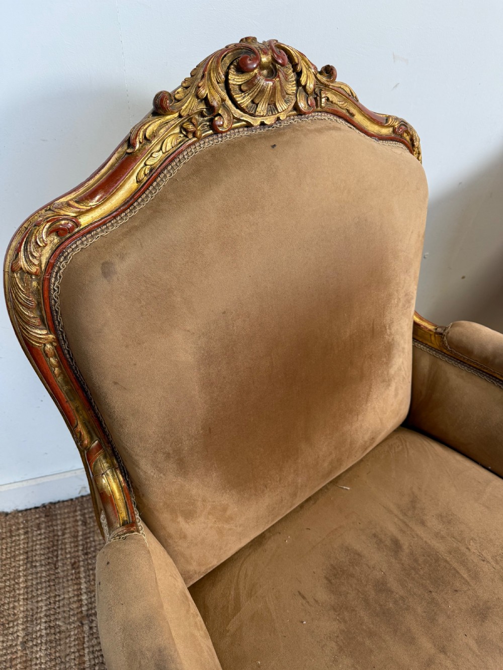 A pair of 19th-century French Napoleon III giltwood armchairs upholstered in taupe velvet with carved floral crests and cabriole legs. View III