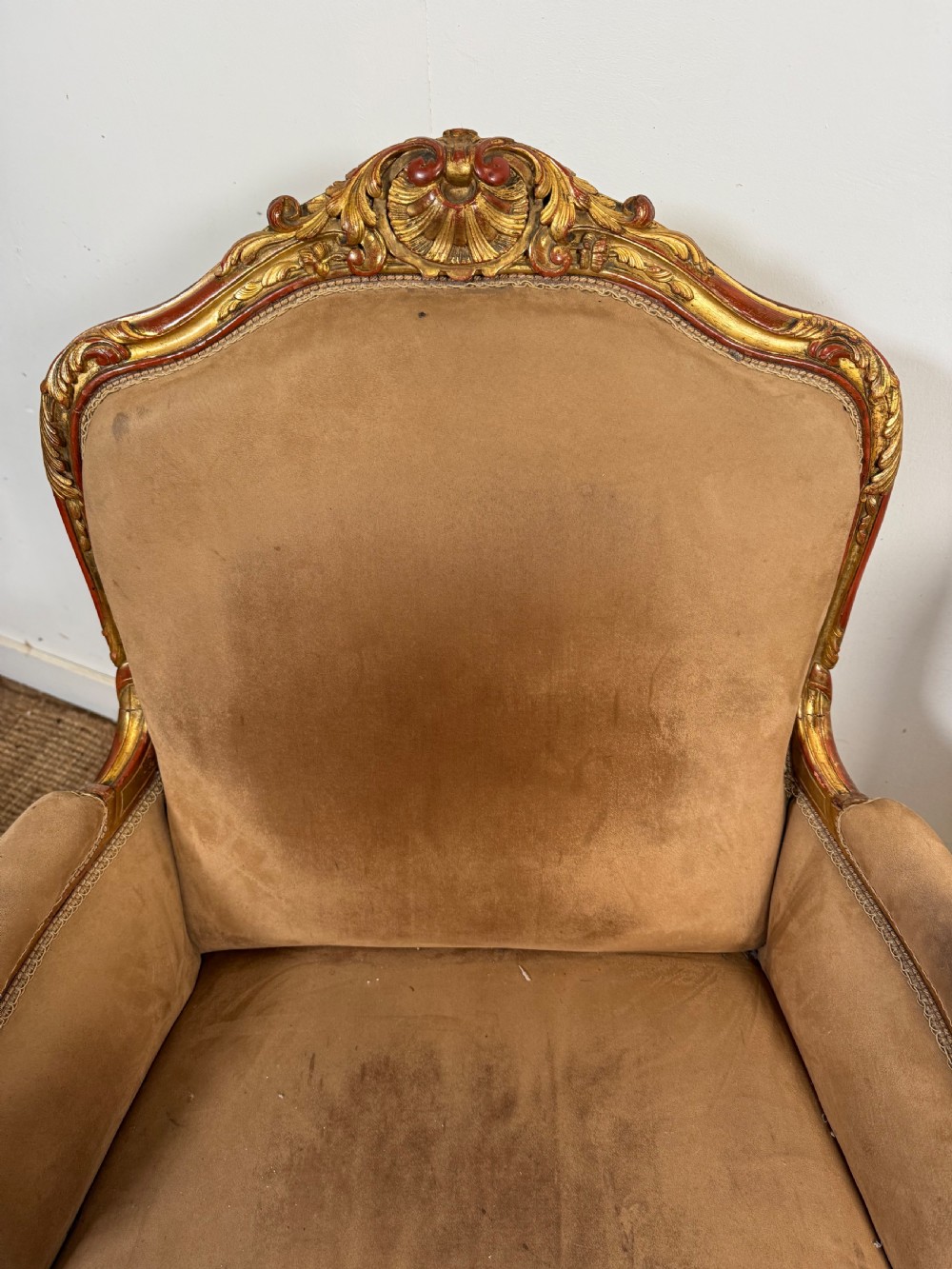 A pair of 19th-century French Napoleon III giltwood armchairs upholstered in taupe velvet with carved floral crests and cabriole legs. View IV