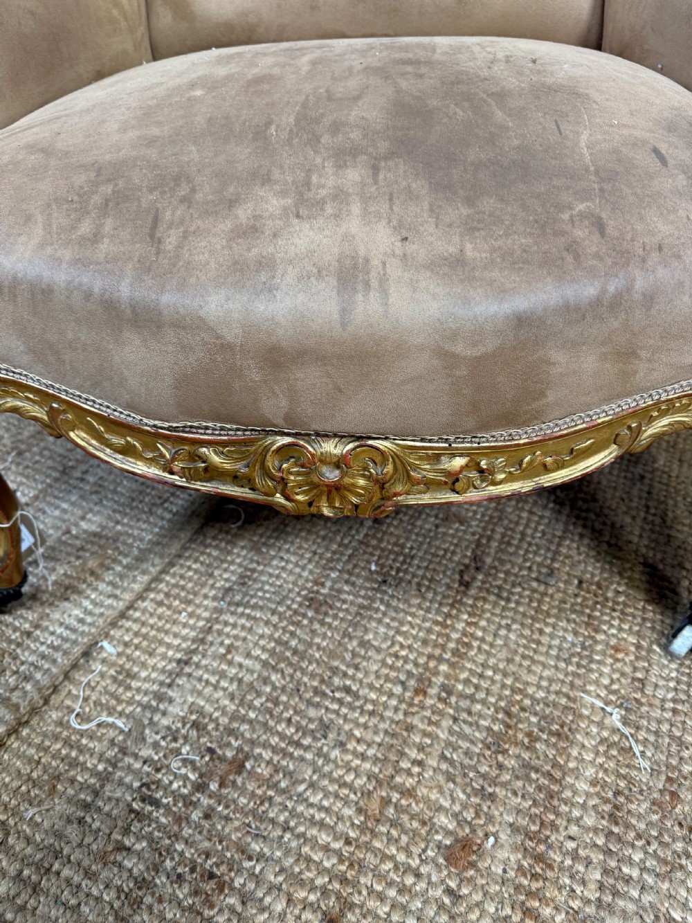 A pair of 19th-century French Napoleon III giltwood armchairs upholstered in taupe velvet with carved floral crests and cabriole legs. View VII