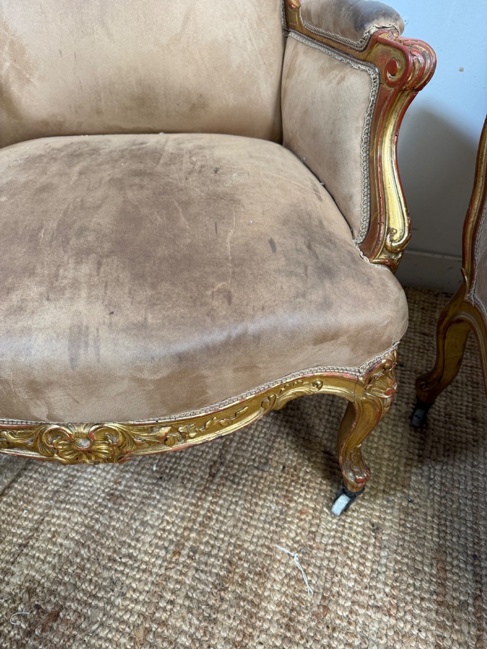 A pair of 19th-century French Napoleon III giltwood armchairs upholstered in taupe velvet with carved floral crests and cabriole legs. View VIII