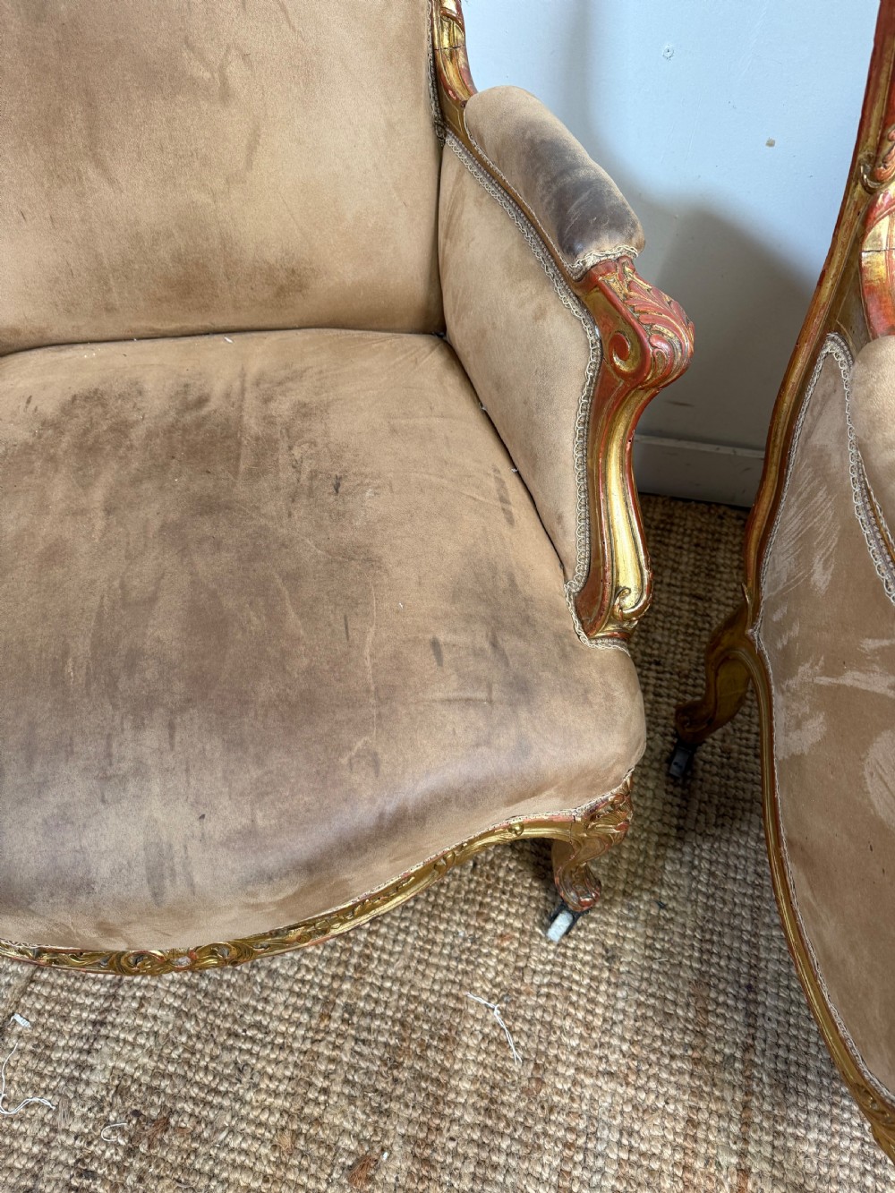 A pair of 19th-century French Napoleon III giltwood armchairs upholstered in taupe velvet with carved floral crests and cabriole legs. View IX
