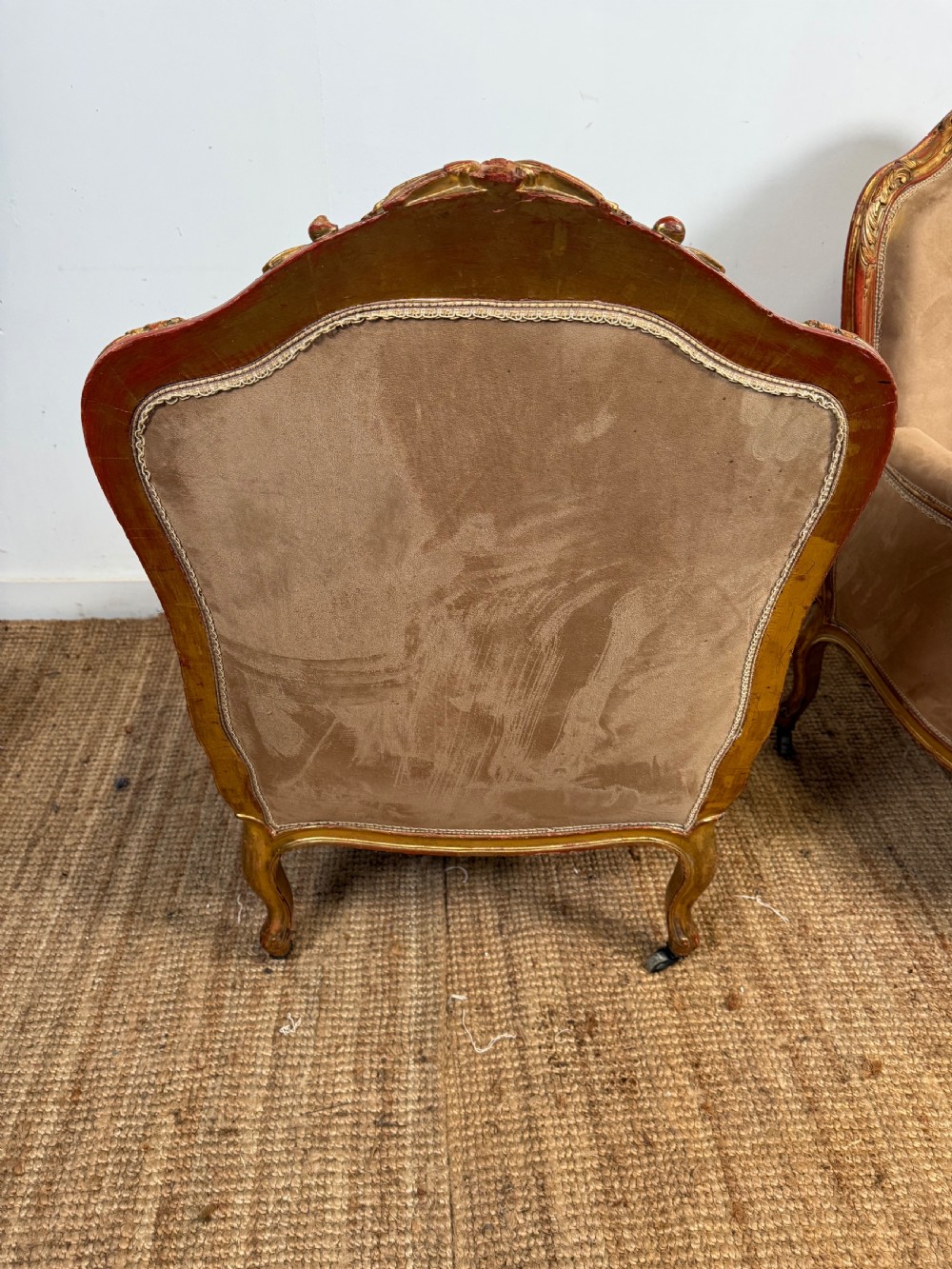 A pair of 19th-century French Napoleon III giltwood armchairs upholstered in taupe velvet with carved floral crests and cabriole legs. View XI