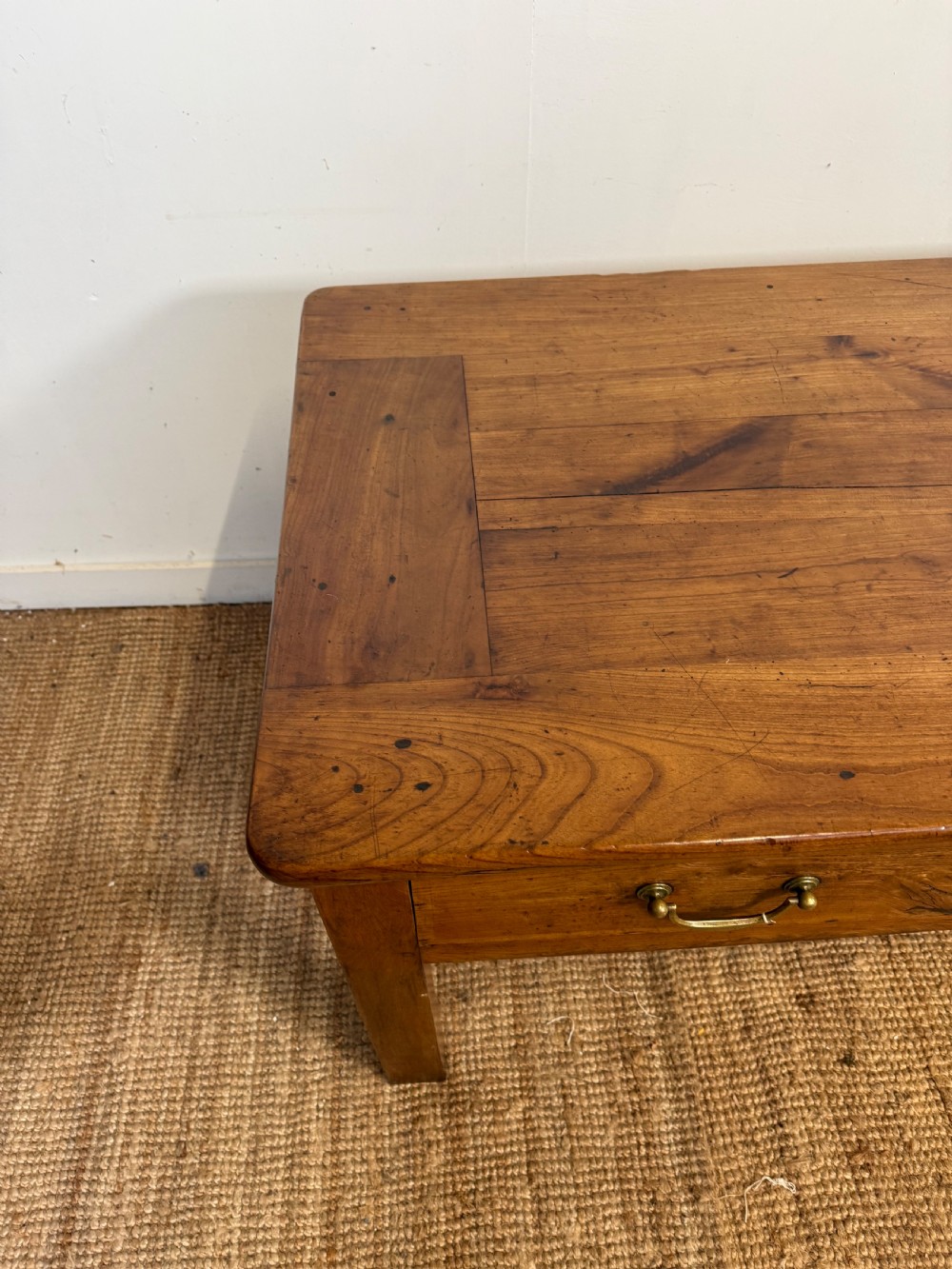 A 19th-century French provincial wooden dresser base featuring three drawers with brass bail handles set on straight legs. View VIII