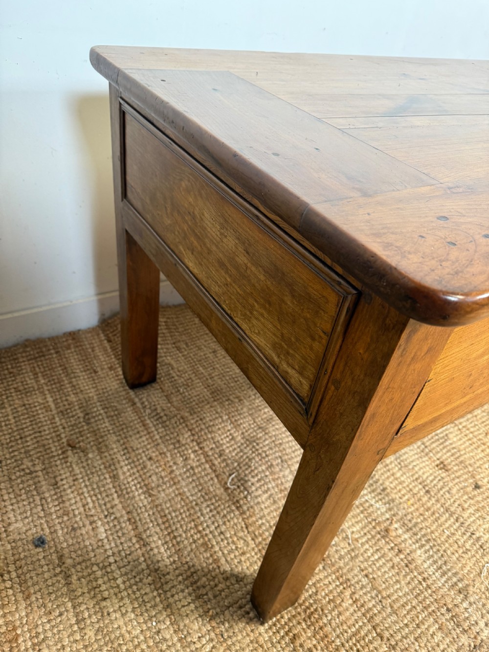 A 19th-century French provincial wooden dresser base featuring three drawers with brass bail handles set on straight legs. View IX