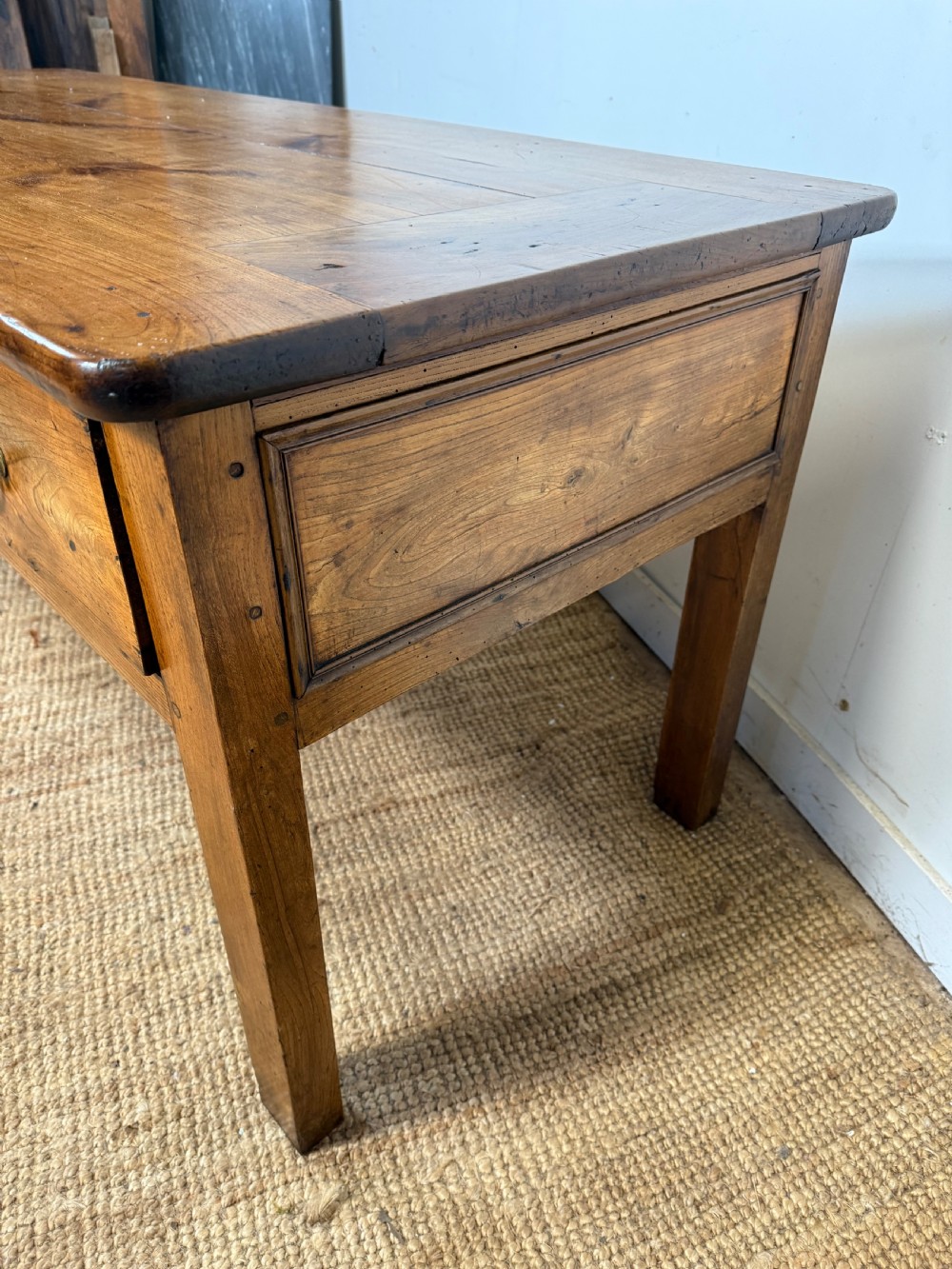 A 19th-century French provincial wooden dresser base featuring three drawers with brass bail handles set on straight legs. View XIV