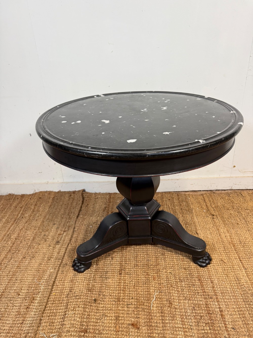 A 19th-century French circular gueridon side table featuring a dark speckled marble top, black painted pedestal support, and scroll feet. View II