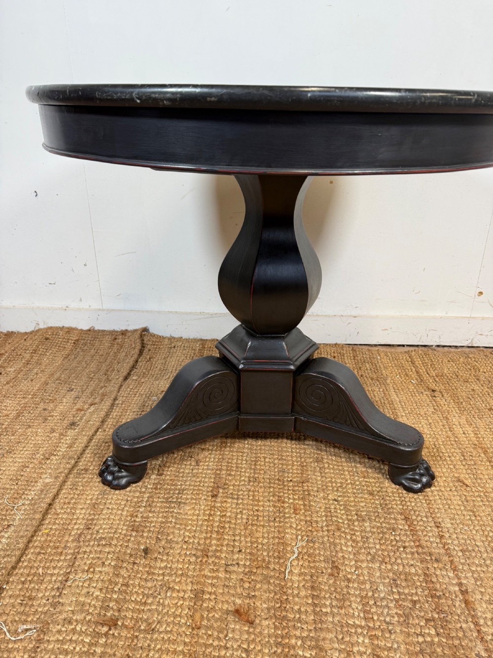 A 19th-century French circular gueridon side table featuring a dark speckled marble top, black painted pedestal support, and scroll feet. View III