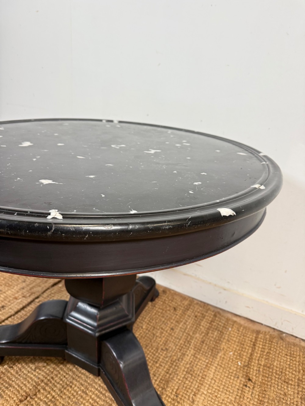 A 19th-century French circular gueridon side table featuring a dark speckled marble top, black painted pedestal support, and scroll feet. View V