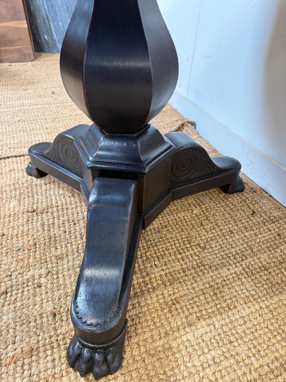 A 19th-century French circular gueridon side table featuring a dark speckled marble top, black painted pedestal support, and scroll feet. View VII