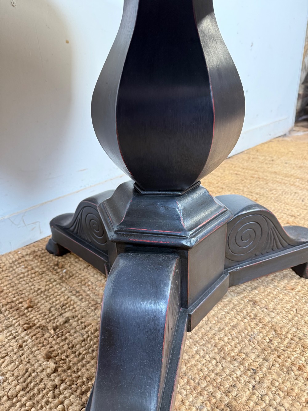 A 19th-century French circular gueridon side table featuring a dark speckled marble top, black painted pedestal support, and scroll feet. View IX
