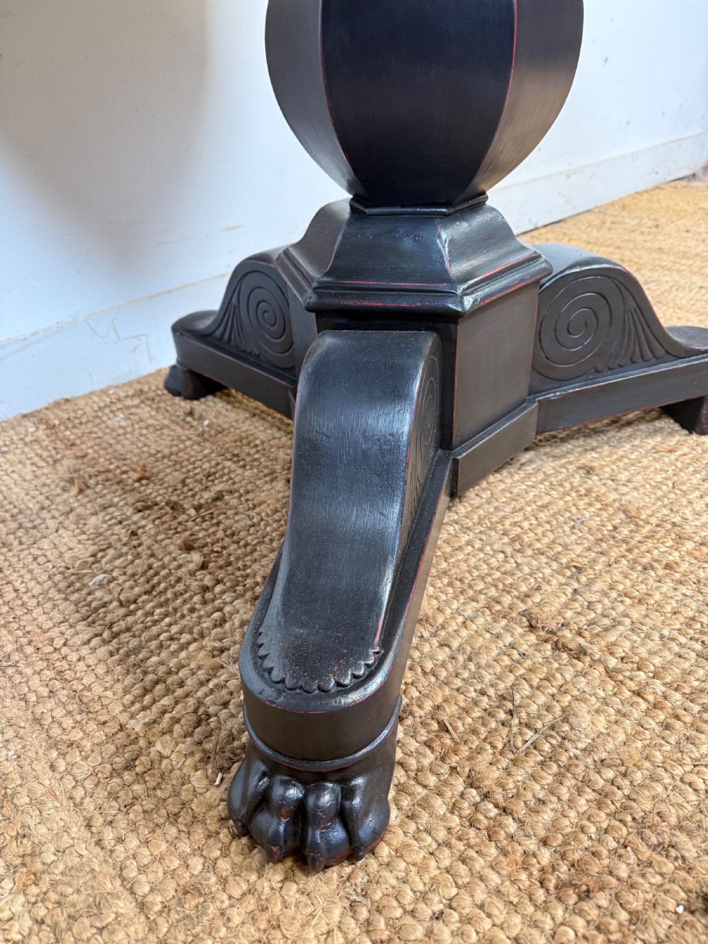 A 19th-century French circular gueridon side table featuring a dark speckled marble top, black painted pedestal support, and scroll feet. View X