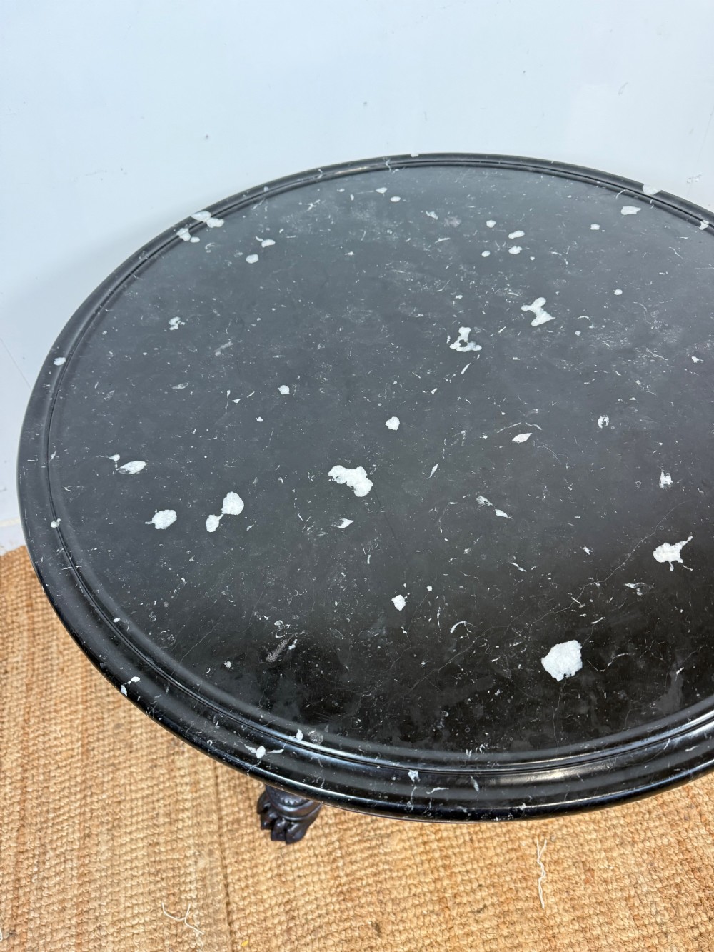 A 19th-century French circular gueridon side table featuring a dark speckled marble top, black painted pedestal support, and scroll feet. View XI