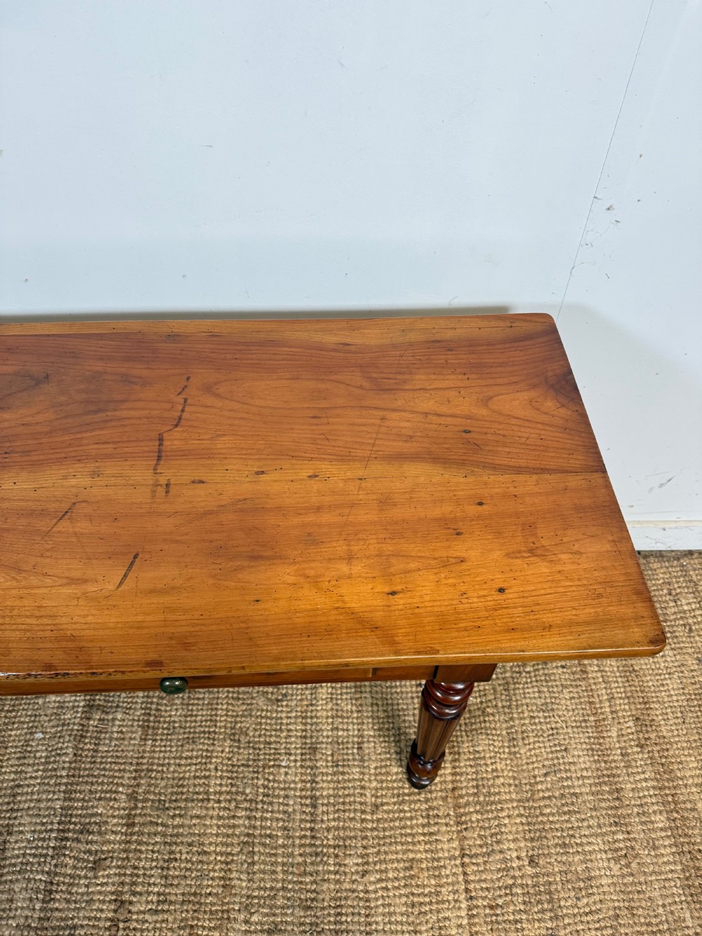 A 19th-century French cherrywood console table featuring two frieze drawers with brass knobs and four turned, fluted legs. View VI