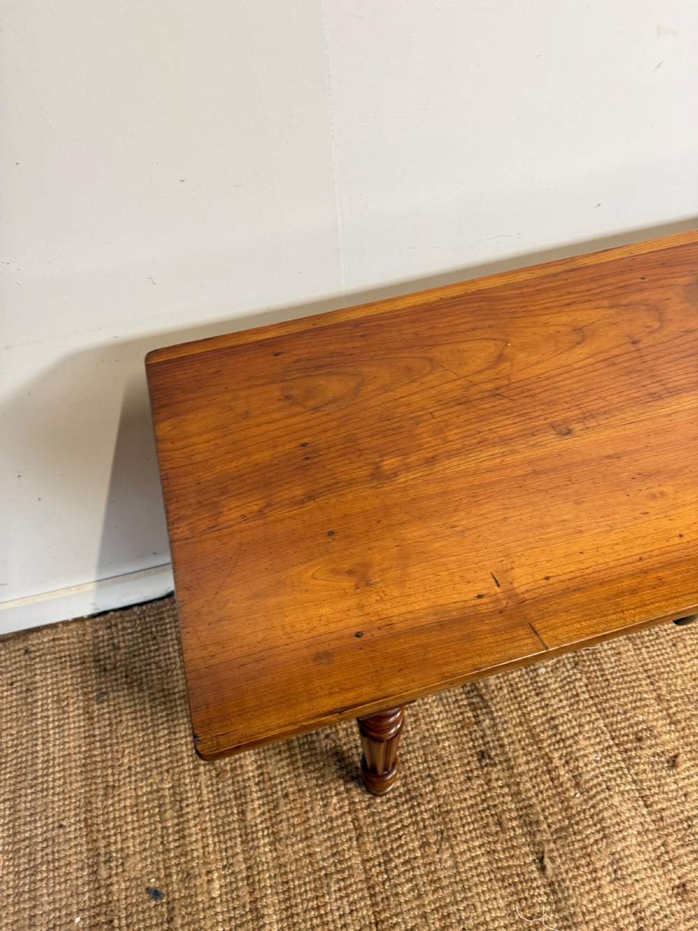 A 19th-century French cherrywood console table featuring two frieze drawers with brass knobs and four turned, fluted legs. View VIII