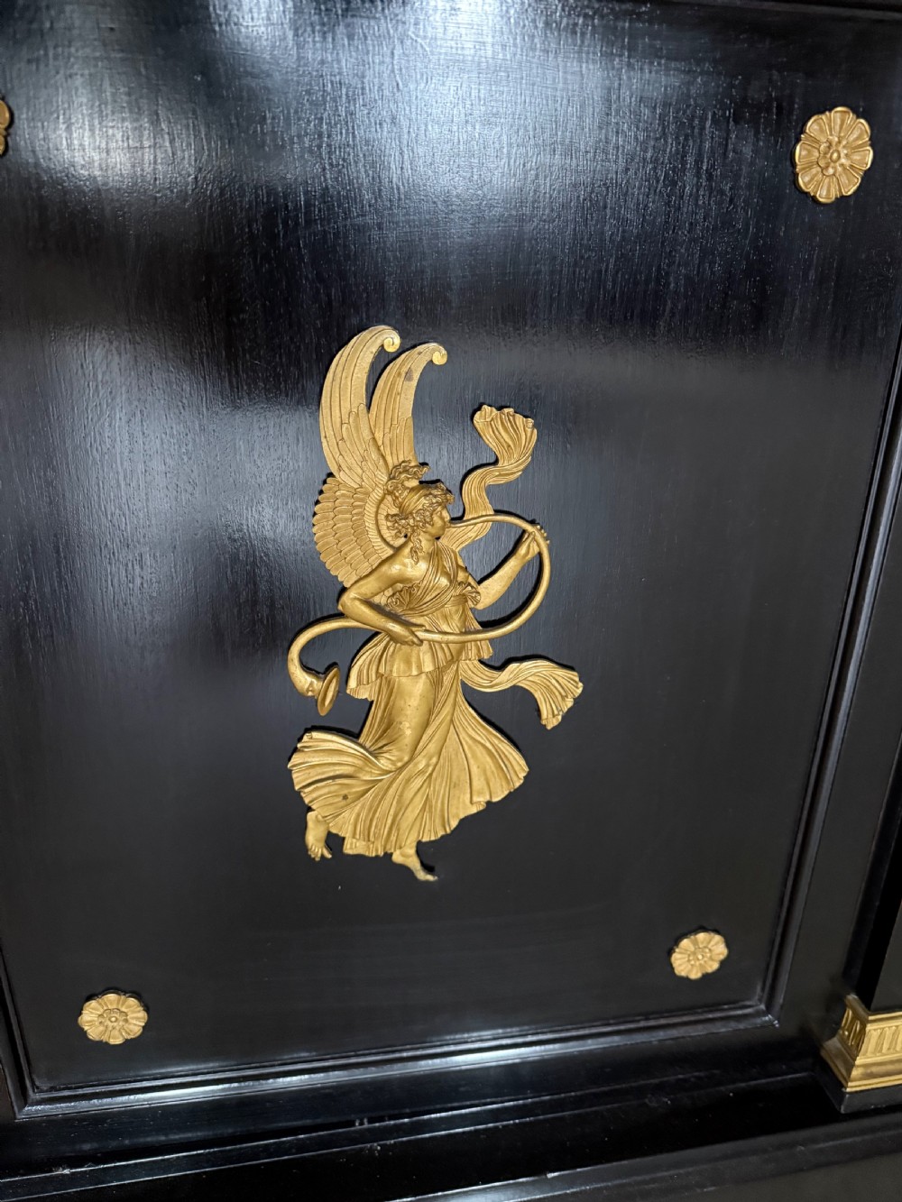 A large ebonised three-door glazed bookcase featuring gold-toned gilt-bronze mounts, arched glass panels, and an oak interior. View X