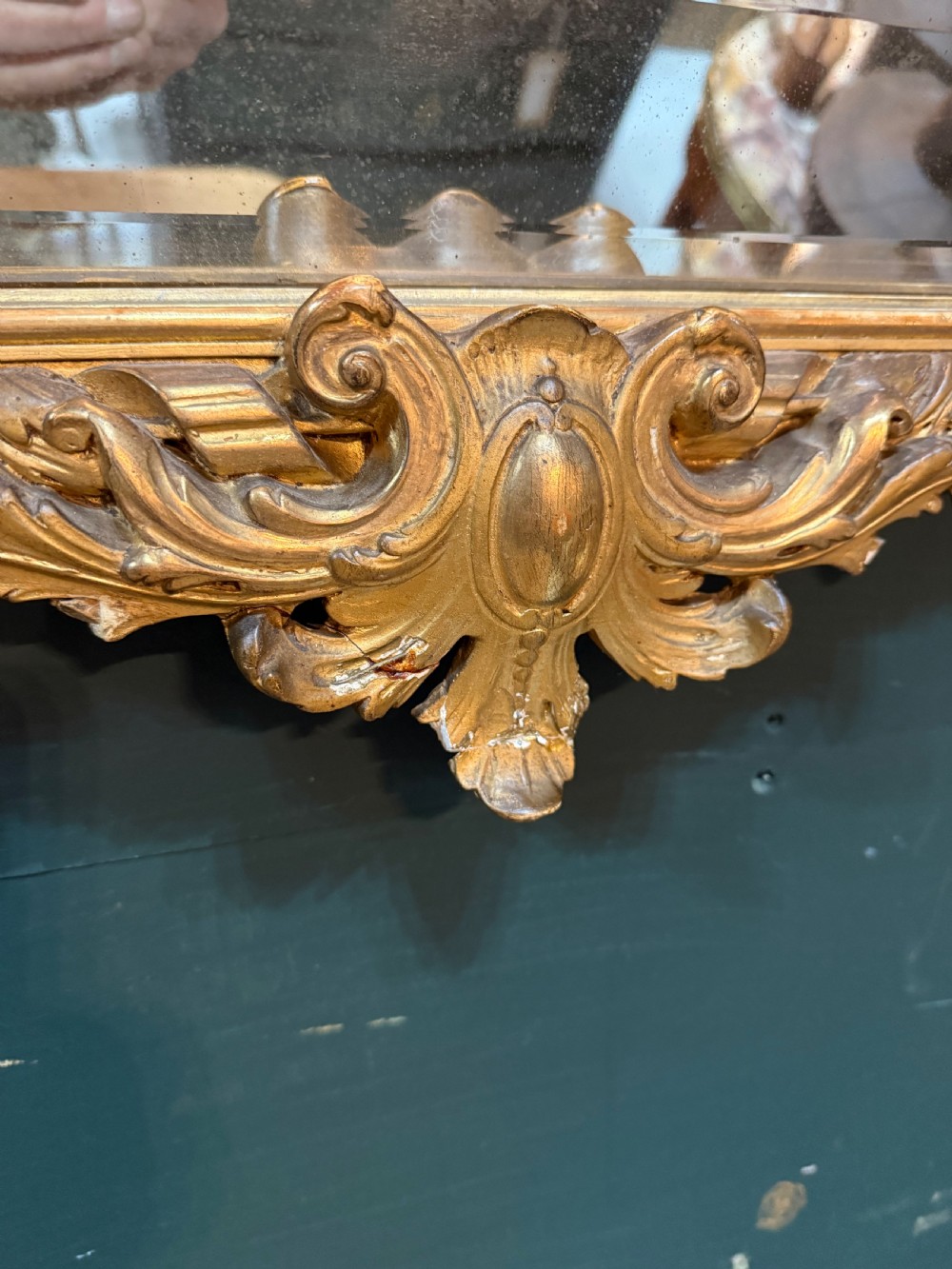 A 19th-century rectangular French giltwood wall mirror featuring elaborate cresting with cherubs, an urn finial, acanthus leaf scrolling, and a beaded inner border around a bevelled glass plate. View X