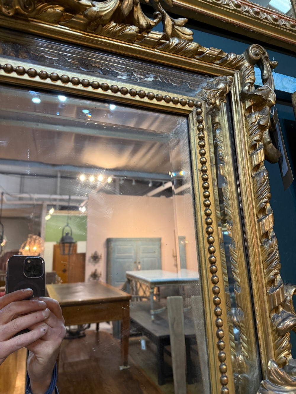 A 19th-century rectangular French giltwood wall mirror featuring elaborate cresting with cherubs, an urn finial, acanthus leaf scrolling, and a beaded inner border around a bevelled glass plate. View XII