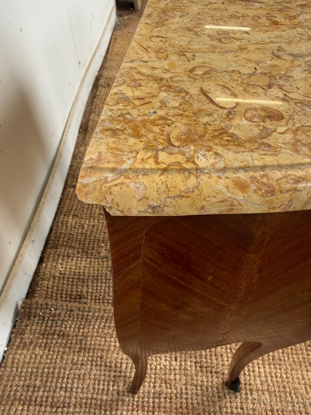 A pair of French Louis XV style bedside cabinets featuring variegated yellow marble tops, three marquetry inlaid drawers, brass mounts, and slender cabriole legs. View VII