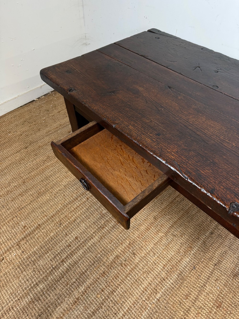A long 18th century dark oak farmhouse dining table with a thick plank top and square legs. View IX