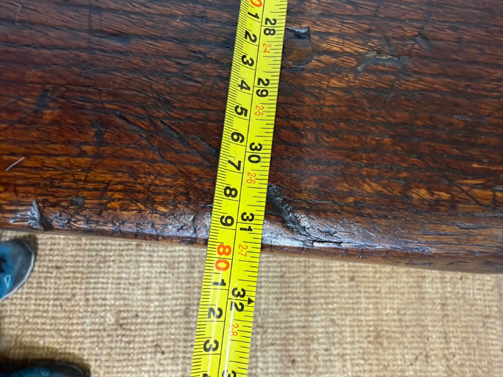 A long 18th century dark oak farmhouse dining table with a thick plank top and square legs. View XIV