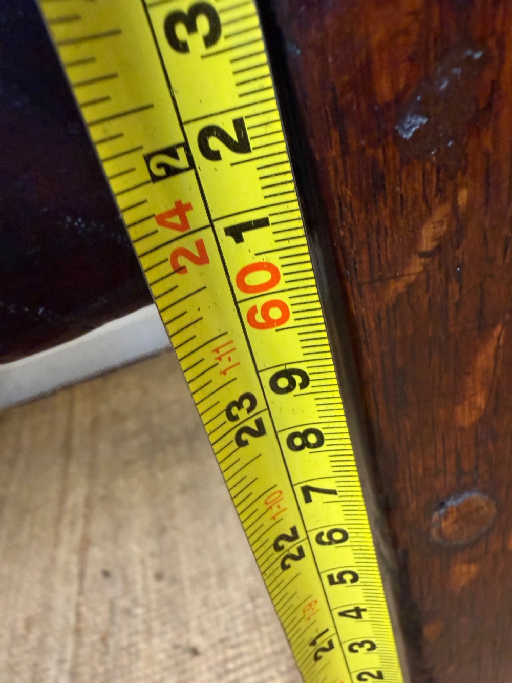 A long 18th century dark oak farmhouse dining table with a thick plank top and square legs. View XVI
