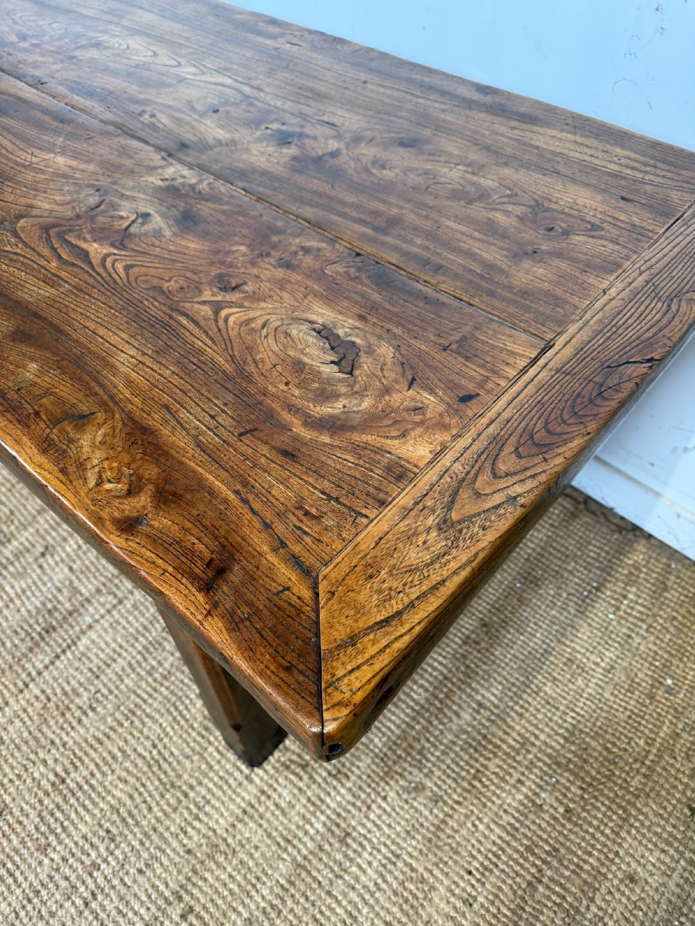 A long 19th-century rustic elm farmhouse dining table featuring a solid plank top and lower support stretchers. View IV