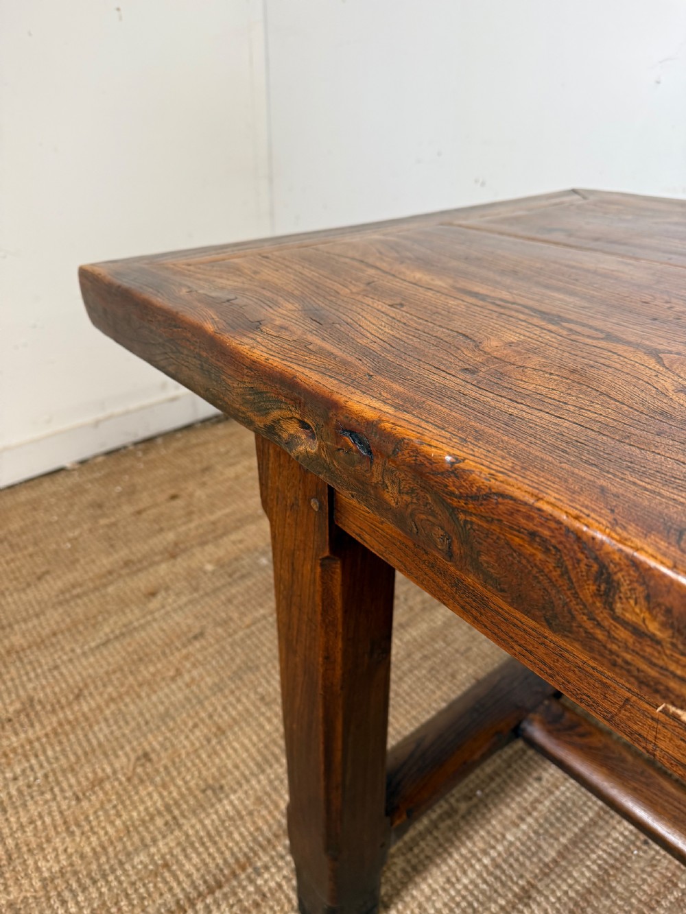 A long 19th-century rustic elm farmhouse dining table featuring a solid plank top and lower support stretchers. View VIII