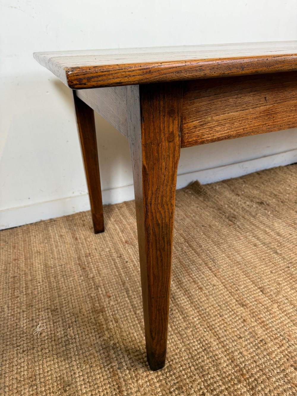 A rectangular late 19th-century chestnut farmhouse table featuring a plank top and four straight tapered legs. View VII