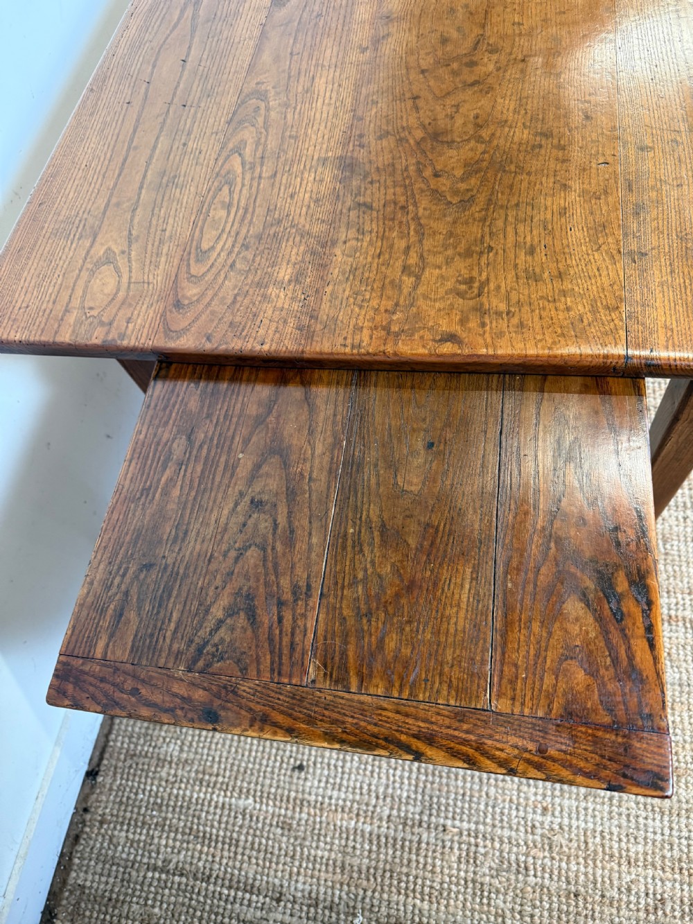 A rectangular late 19th-century chestnut farmhouse table featuring a plank top and four straight tapered legs. View X