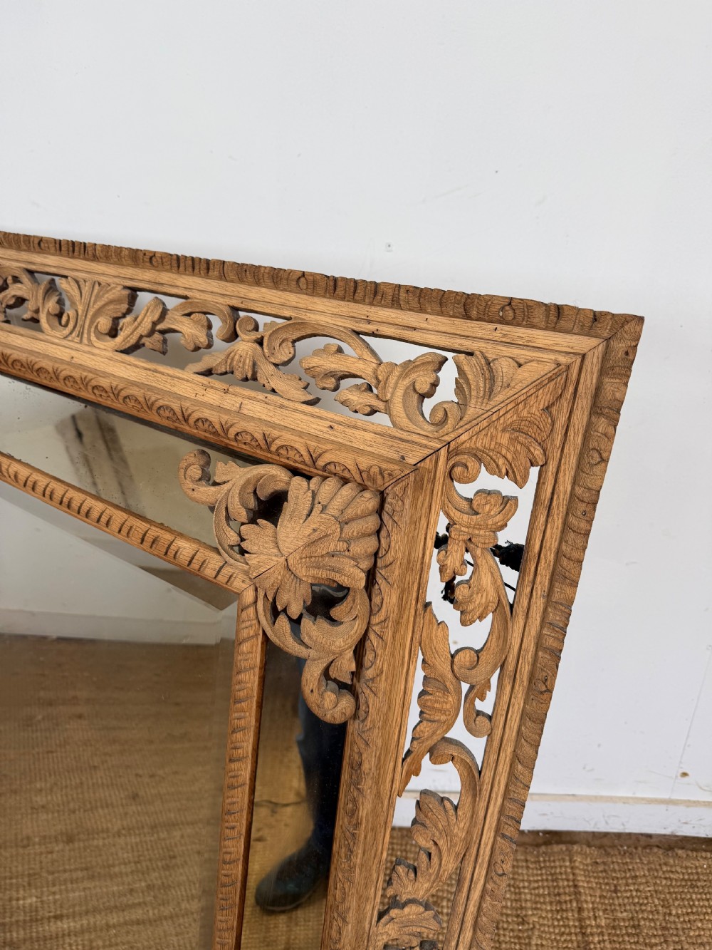 A large rectangular Henri II style scrubbed oak cushion mirror featuring intricate acanthus leaf relief carving on an openwork border. View II