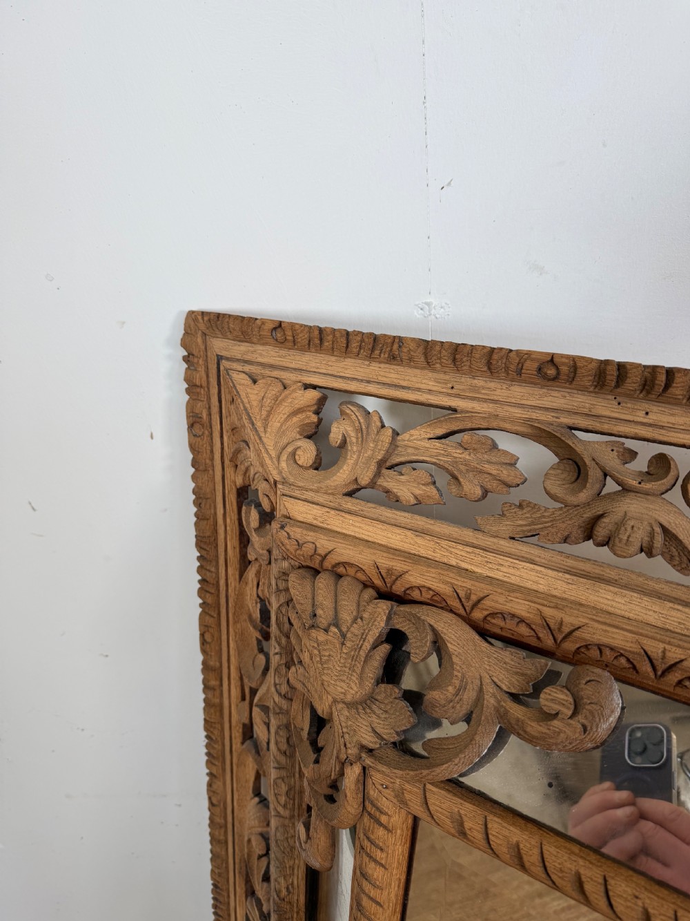 A large rectangular Henri II style scrubbed oak cushion mirror featuring intricate acanthus leaf relief carving on an openwork border. View IV