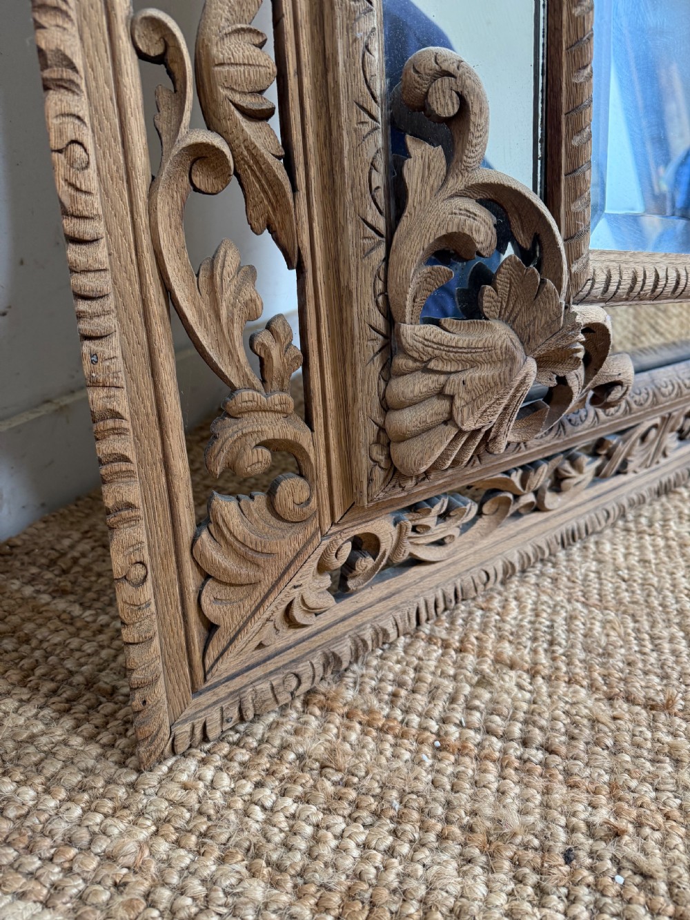 A large rectangular Henri II style scrubbed oak cushion mirror featuring intricate acanthus leaf relief carving on an openwork border. View VI
