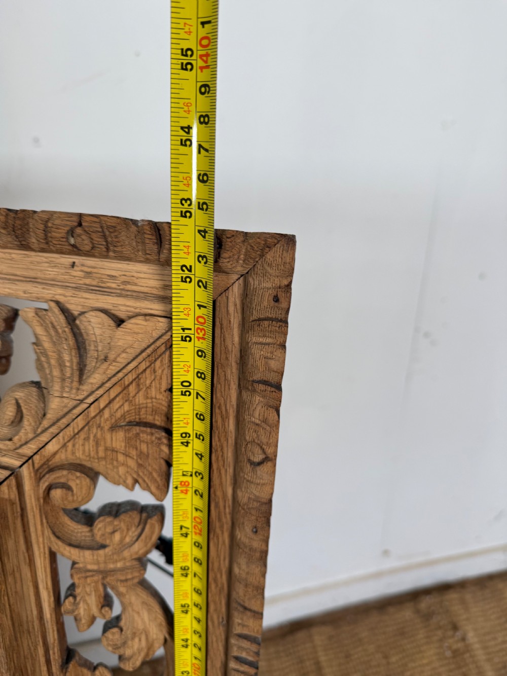 A large rectangular Henri II style scrubbed oak cushion mirror featuring intricate acanthus leaf relief carving on an openwork border. View VIII