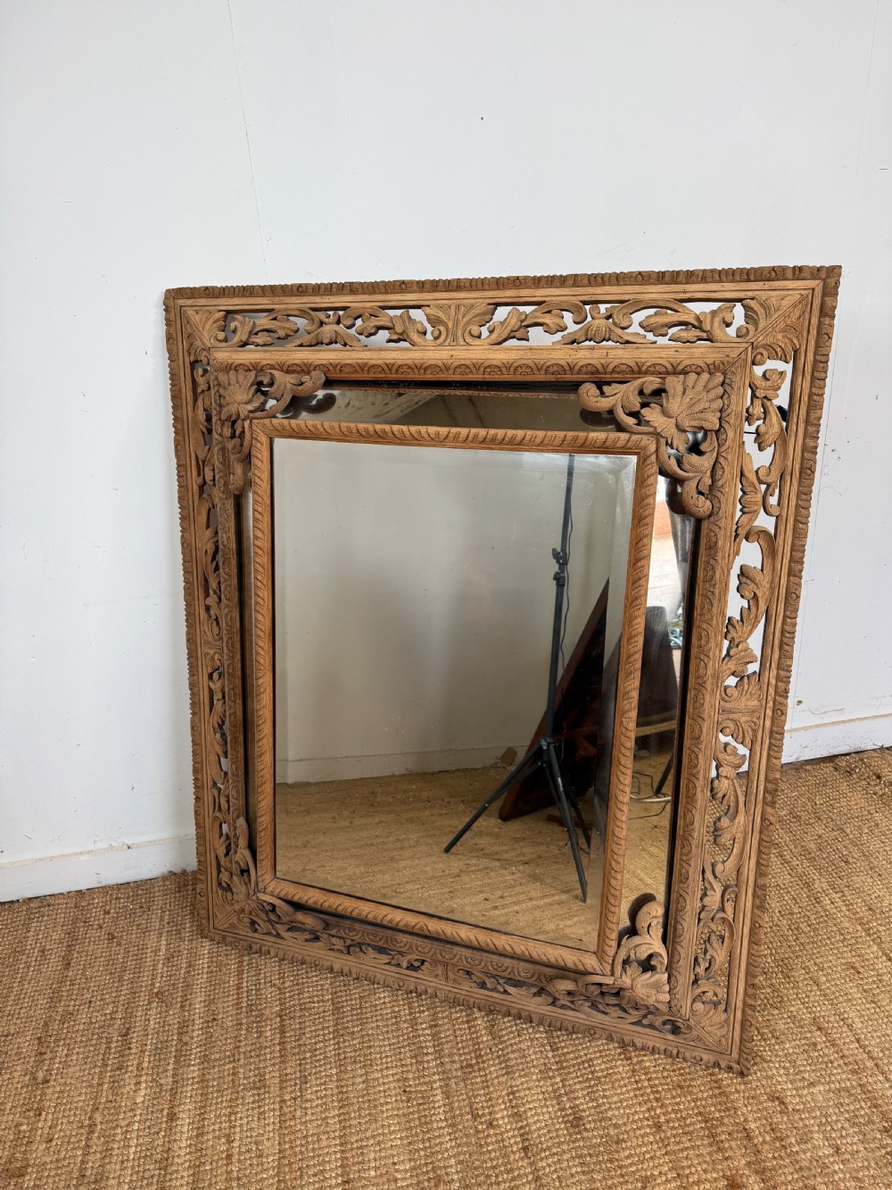 A large rectangular Henri II style scrubbed oak cushion mirror featuring intricate acanthus leaf relief carving on an openwork border. View XI